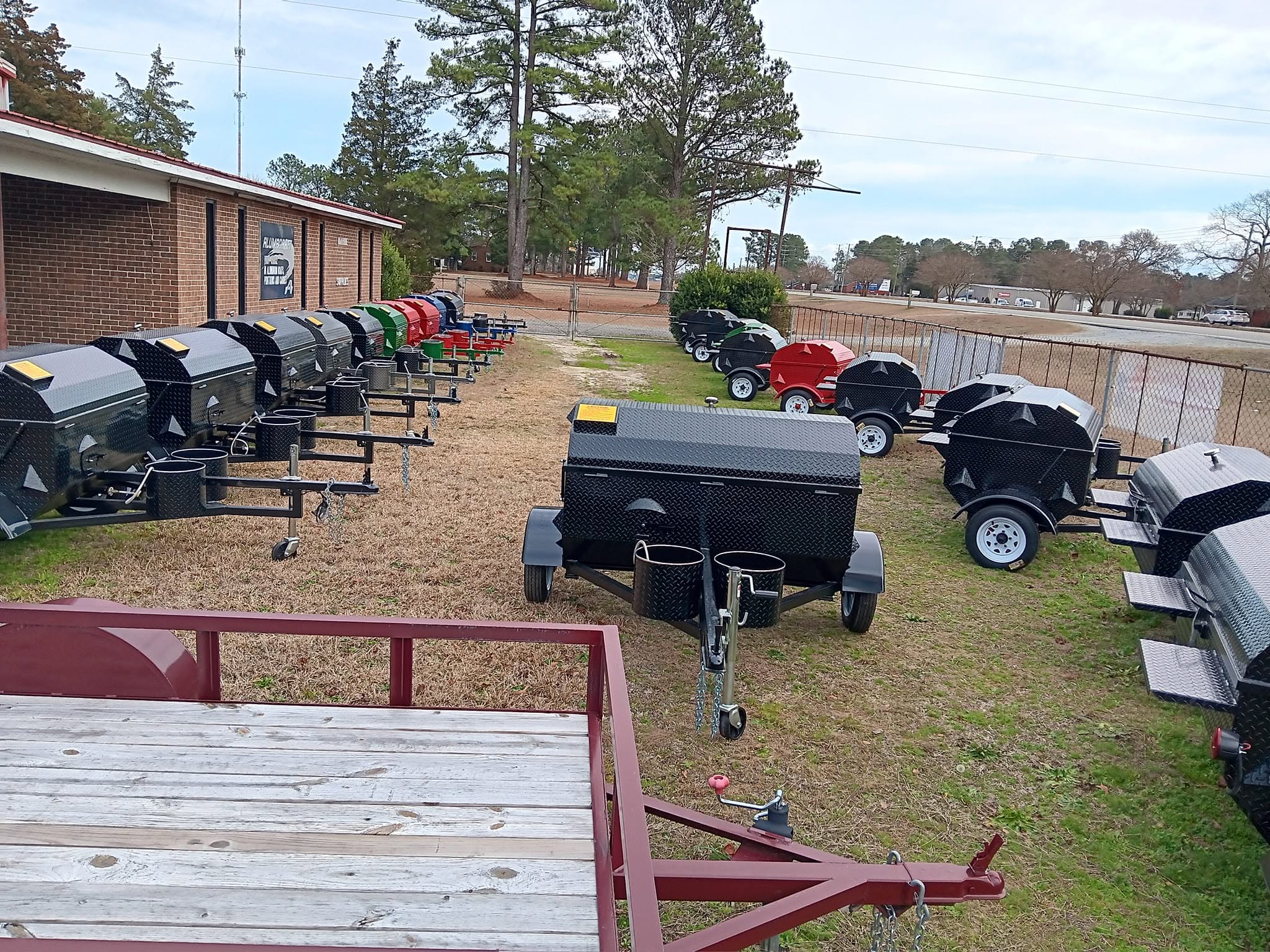 Lineup of custom towable BBQ cooker trailers built by Big Larry's Cookers